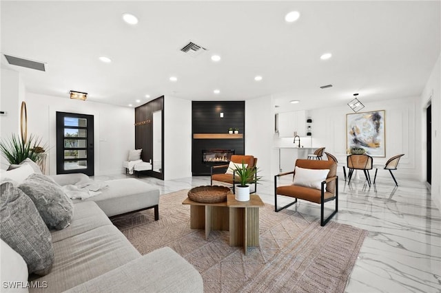 living room with a large fireplace and sink