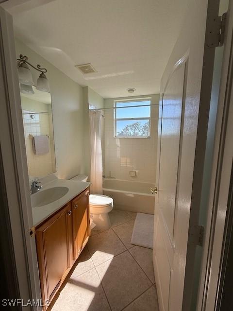 full bathroom with tile patterned flooring, vanity, shower / bath combination with curtain, and toilet