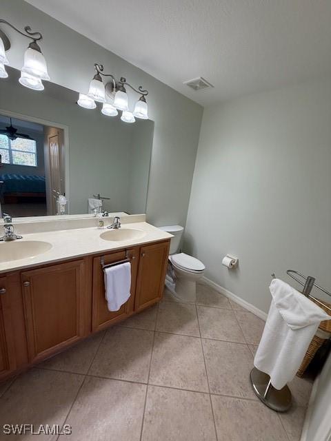 bathroom featuring tile patterned floors, vanity, and toilet