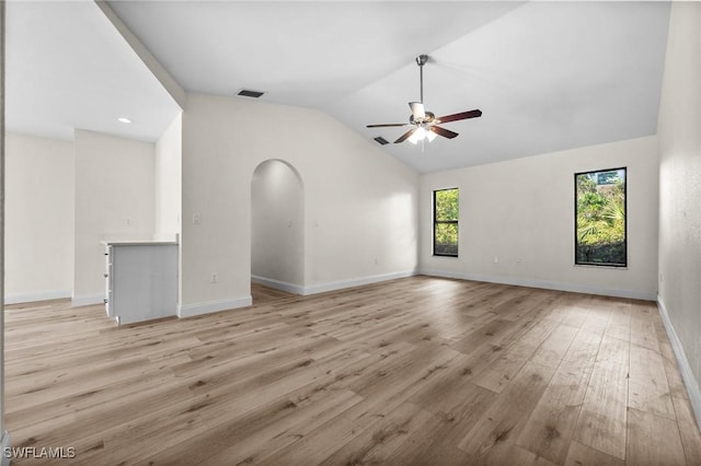 unfurnished living room with ceiling fan, light wood-type flooring, and vaulted ceiling