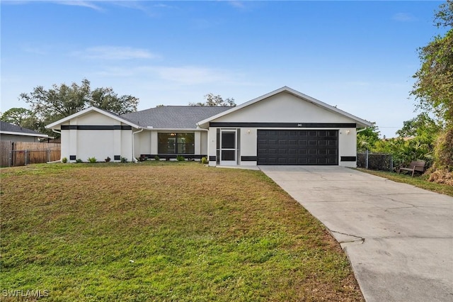 ranch-style home featuring a front lawn and a garage