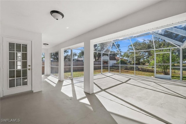 unfurnished sunroom featuring vaulted ceiling