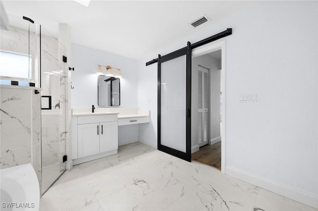 bathroom featuring a shower with door and vanity