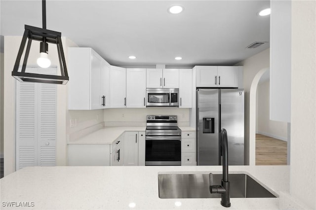 kitchen featuring sink, white cabinets, and appliances with stainless steel finishes