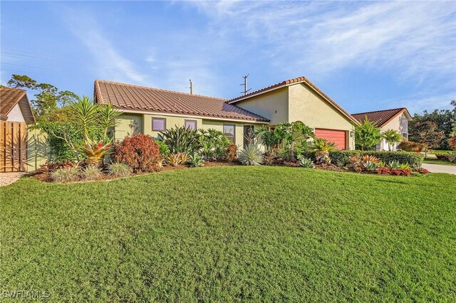 view of front of house with a front yard and a garage