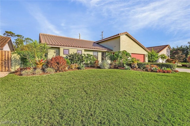 view of front of home featuring a garage and a front yard