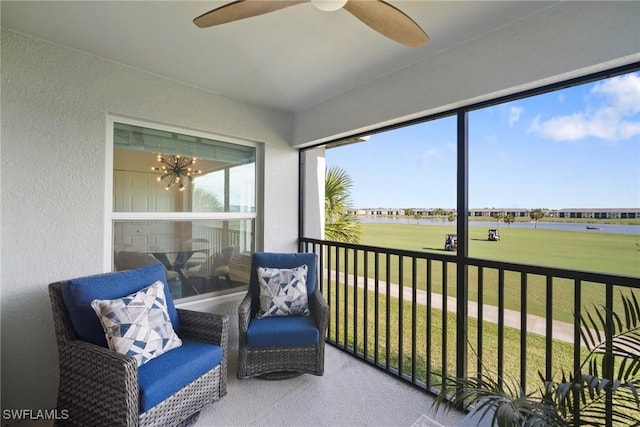 sunroom featuring ceiling fan