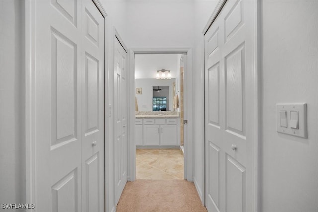 corridor with light colored carpet