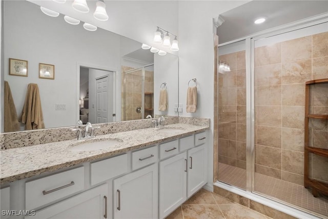 bathroom featuring vanity, tile patterned floors, and a shower with shower door