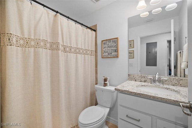 bathroom with vanity, curtained shower, and toilet