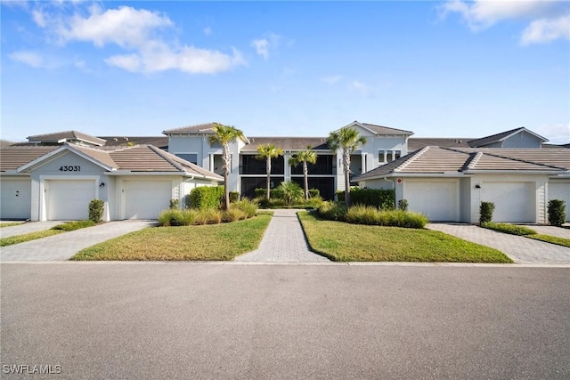 view of front of home with a garage and a front lawn