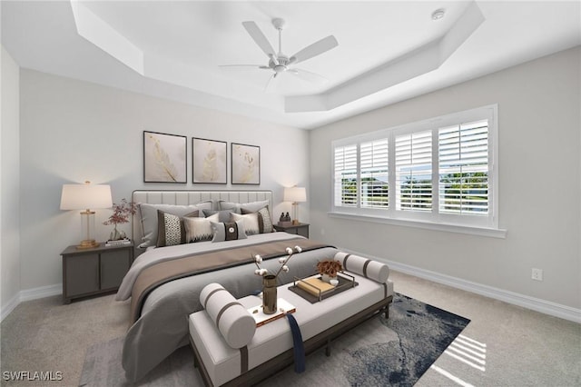 bedroom featuring ceiling fan, a raised ceiling, and carpet floors