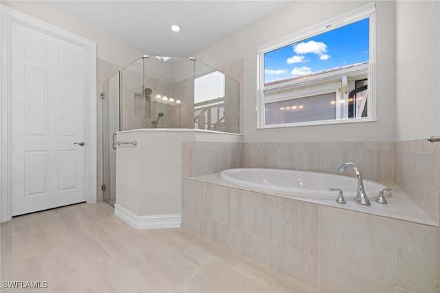 bathroom with tile patterned flooring and independent shower and bath