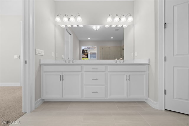 bathroom with tile patterned flooring, vanity, and a shower with shower door