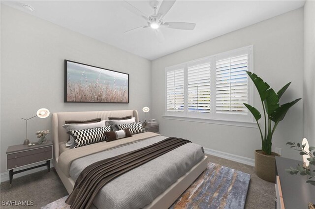 bedroom with ceiling fan and dark carpet