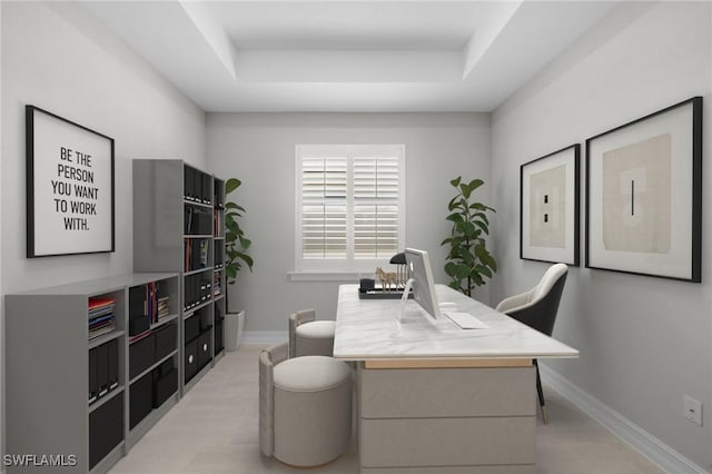 home office featuring a raised ceiling