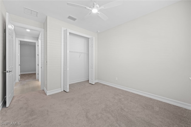 unfurnished bedroom with ceiling fan, a closet, and light carpet