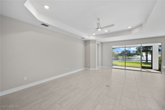 16522 Crescent Beach Way, Bonita Springs, FL 34135 - spare room with a tray ceiling, ceiling fan, recessed lighting, and baseboards