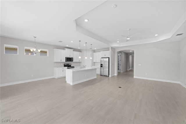 16522 Crescent Beach Way, Bonita Springs, FL 34135 - unfurnished living room with arched walkways, recessed lighting, a ceiling fan, a tray ceiling, and baseboards