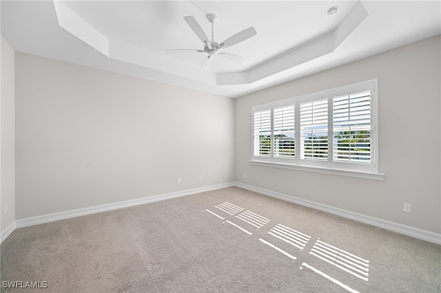 16522 Crescent Beach Way, Bonita Springs, FL 34135 - spare room featuring a tray ceiling, carpet, and ceiling fan