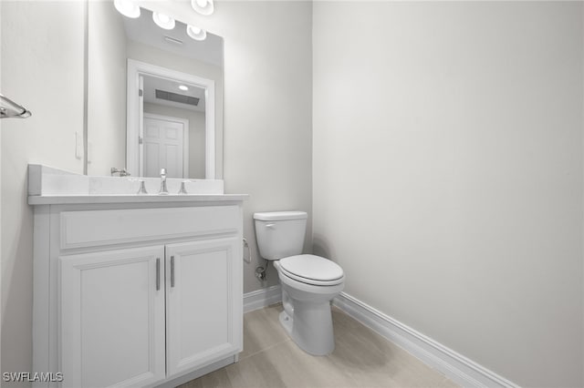 16522 Crescent Beach Way, Bonita Springs, FL 34135 - bathroom with baseboards, toilet, and vanity