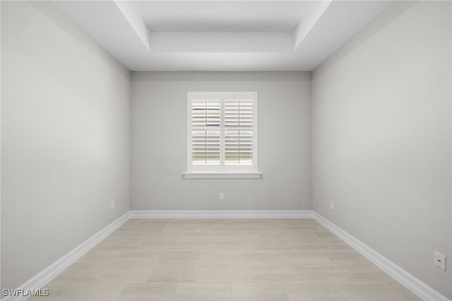 16522 Crescent Beach Way, Bonita Springs, FL 34135 - empty room featuring a raised ceiling and baseboards