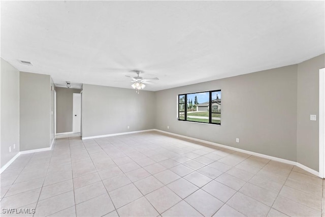 empty room with light tile patterned floors and ceiling fan