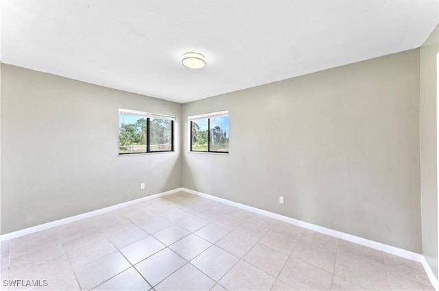 unfurnished room with light tile patterned floors