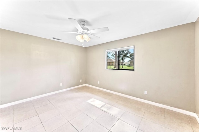 unfurnished room with ceiling fan and light tile patterned flooring