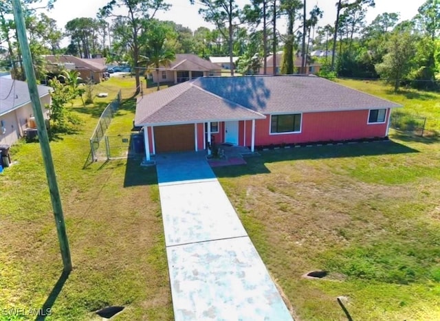 view of front of property with a front yard and a garage