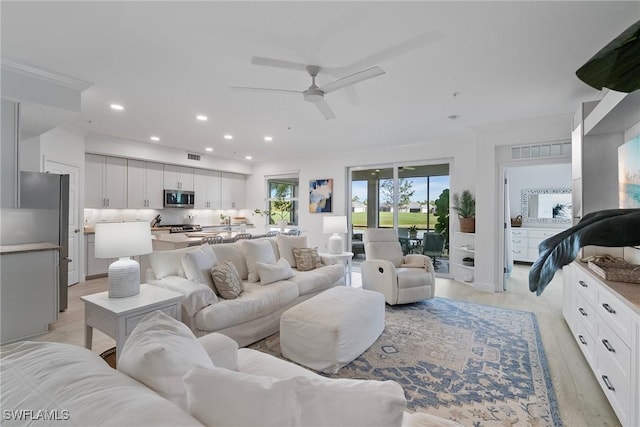 living room featuring ceiling fan and light wood-type flooring