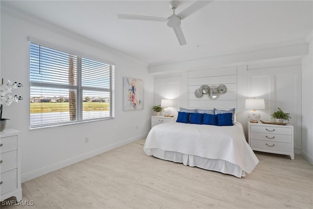 bedroom with ceiling fan, crown molding, and light hardwood / wood-style floors