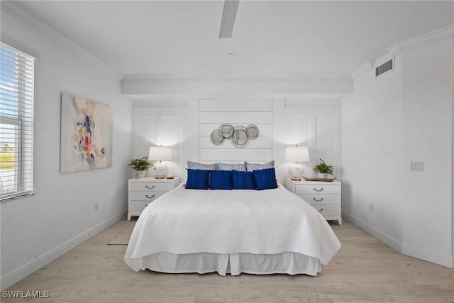 bedroom featuring multiple windows, ceiling fan, light hardwood / wood-style floors, and ornamental molding