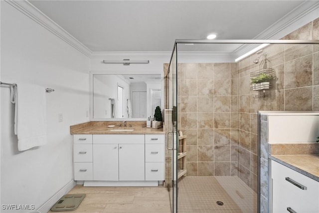 bathroom with vanity, wood-type flooring, an enclosed shower, and ornamental molding