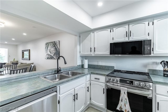 kitchen with white cabinets, sink, kitchen peninsula, and stainless steel appliances