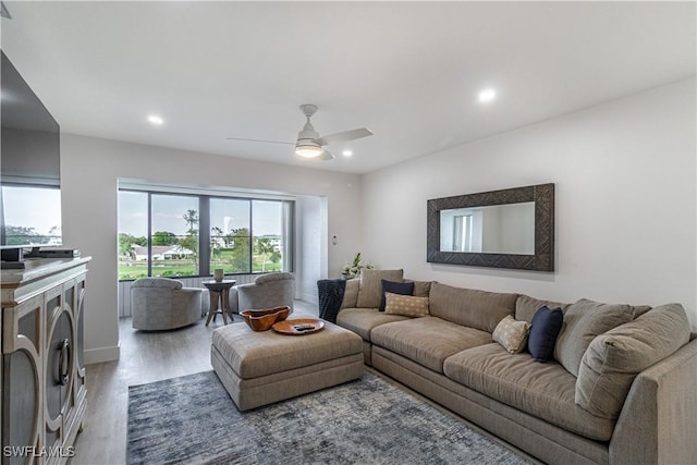 living room with hardwood / wood-style flooring and ceiling fan