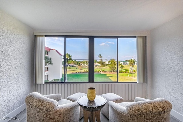 sitting room with hardwood / wood-style floors and a wealth of natural light