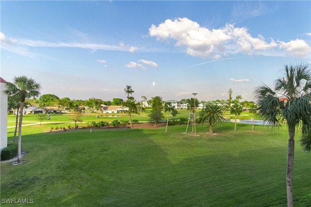 view of community with a water view and a lawn