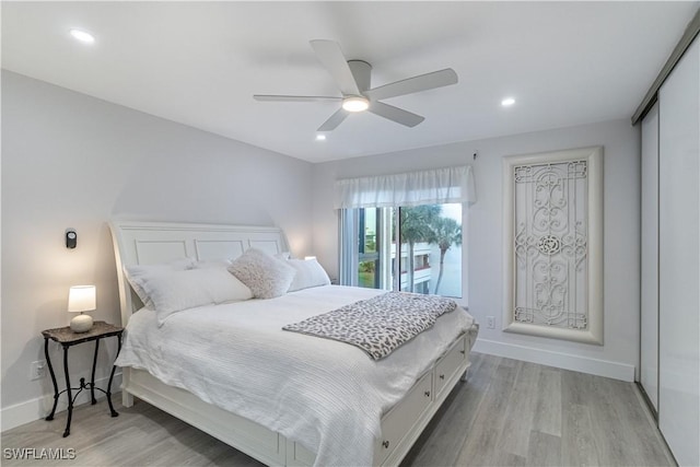 bedroom featuring ceiling fan, a closet, and light hardwood / wood-style floors