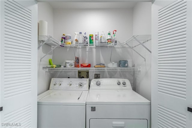 clothes washing area with washing machine and dryer