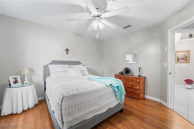 bedroom with light hardwood / wood-style flooring and ceiling fan