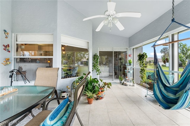 sunroom / solarium with ceiling fan and lofted ceiling