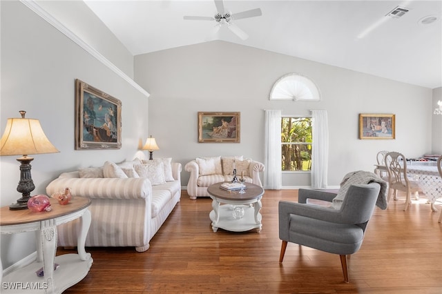 living room featuring ceiling fan, wood-type flooring, and vaulted ceiling