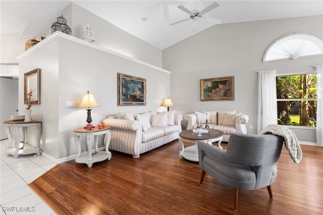 living room featuring hardwood / wood-style flooring, high vaulted ceiling, and ceiling fan