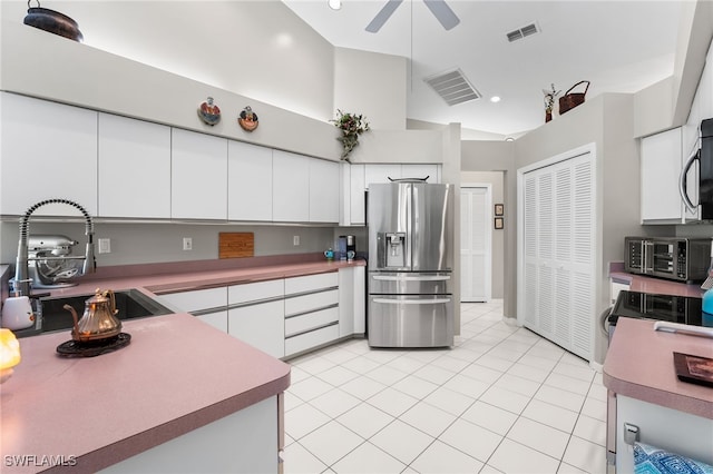 kitchen with white cabinetry, sink, ceiling fan, stainless steel appliances, and light tile patterned floors