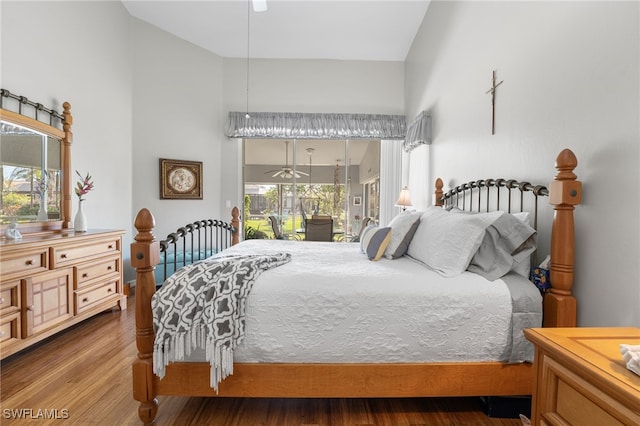 bedroom with hardwood / wood-style floors, access to outside, multiple windows, and ceiling fan