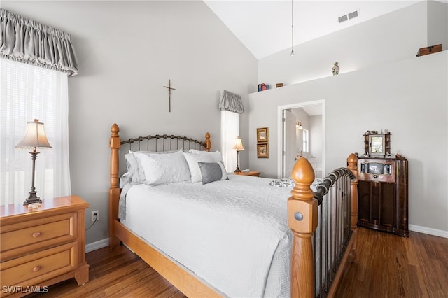 bedroom with dark hardwood / wood-style flooring and lofted ceiling