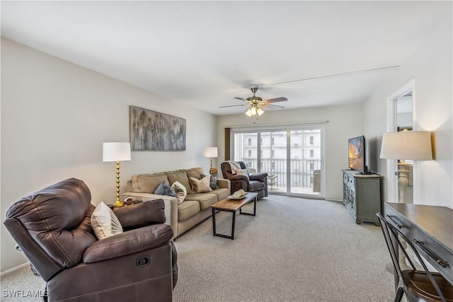 living room featuring light colored carpet and ceiling fan