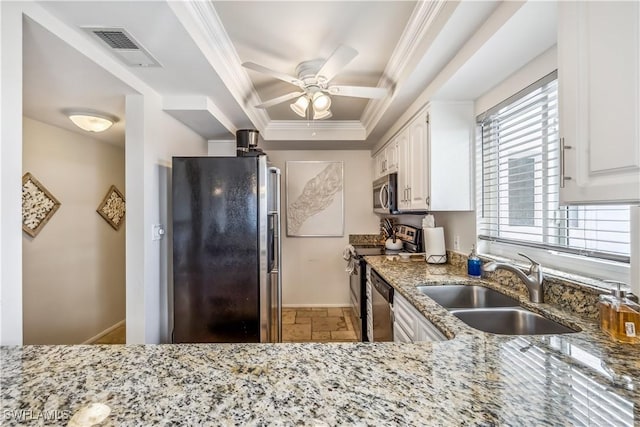 kitchen with white cabinets, sink, ceiling fan, light stone countertops, and stainless steel appliances