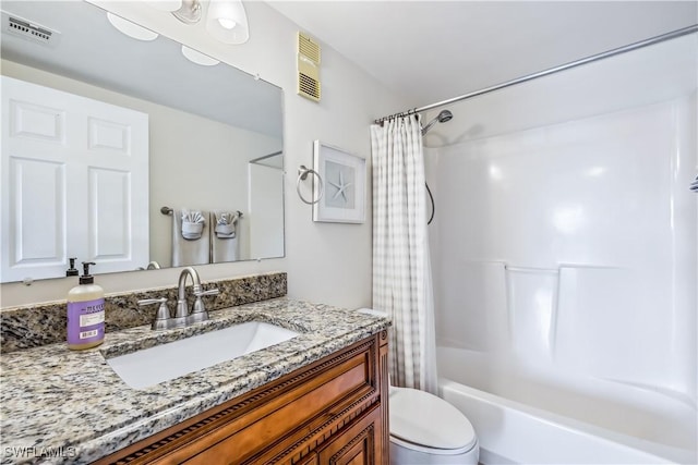 full bathroom featuring shower / tub combo with curtain, vanity, and toilet